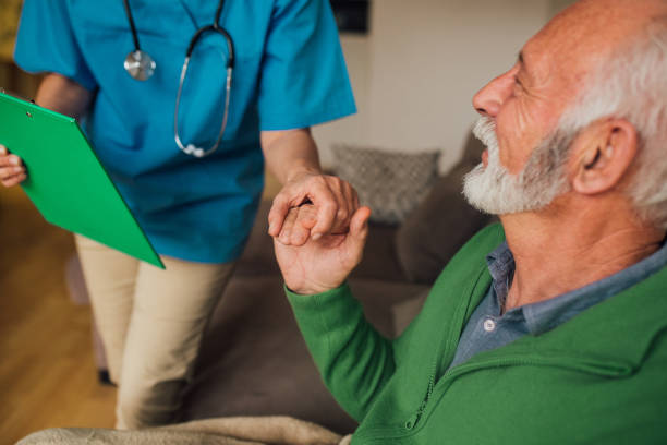 istock Senior man holding nurse by the hand 1085347790