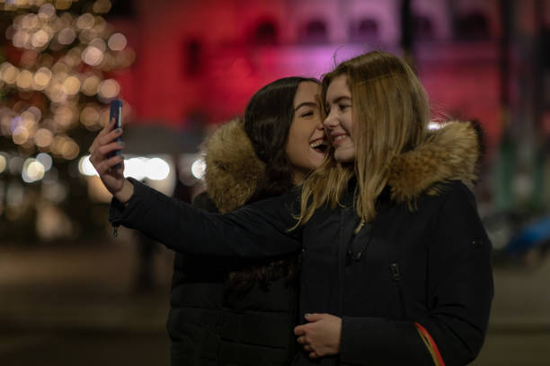 istock Two girlfriends taking selfies in the city 1085347814