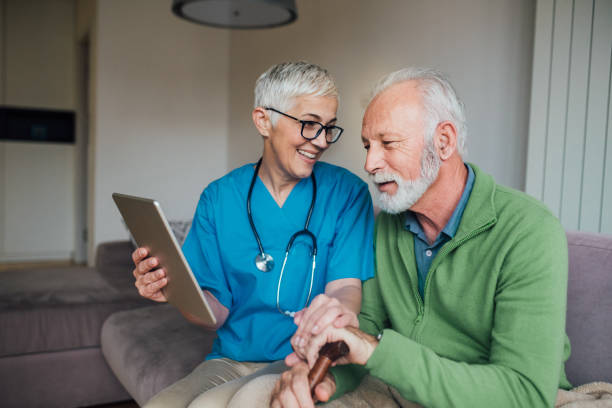 istock Happy patient looking at digital tablet with nurse 1085348052