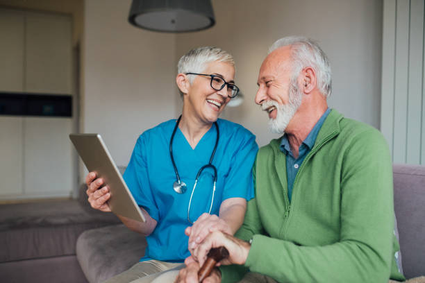 istock Man and woman using digital tablet at nursing home 1085349104