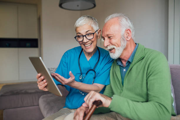 istock Nurse and patient looking at digital tablet and smiling 1085349106