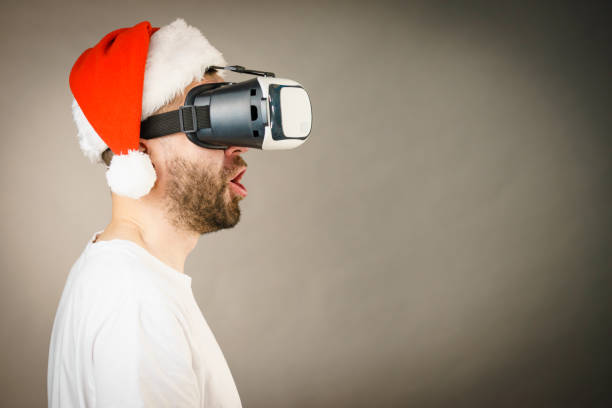istock Man in virtual reality goggles and santa hat 1085349134