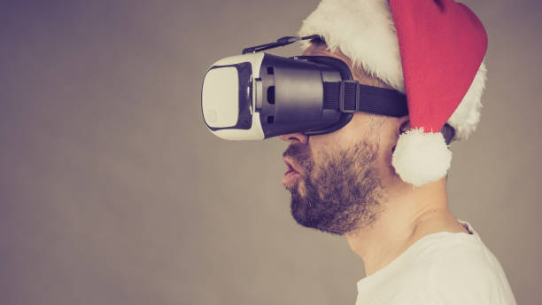 istock Man in virtual reality goggles and santa hat 1085350486
