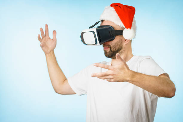 istock Man in virtual reality goggles and santa hat 1085351086