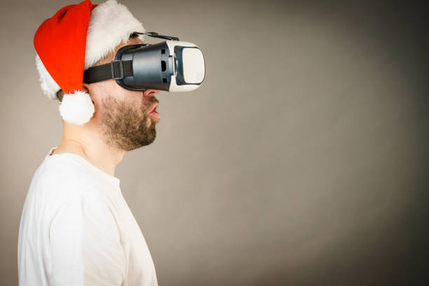 istock Man in virtual reality goggles and santa hat 1085351160