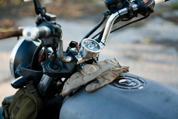 istock Man and old custom cafe-racer Motorcycle on forest  at sunset 1085352828