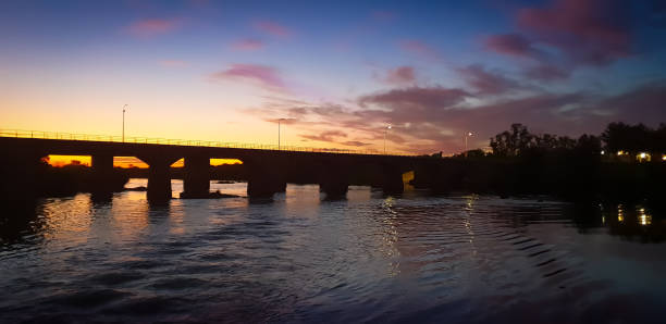 istock Scenic sunset behind a river bridge silhouette 1085353430