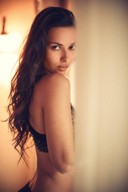 istock Young woman next to the window 1085362712