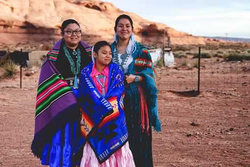 Native American sisters posing for photographs in their native costumes