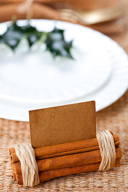 aromatic place card with holly twig in white plate
