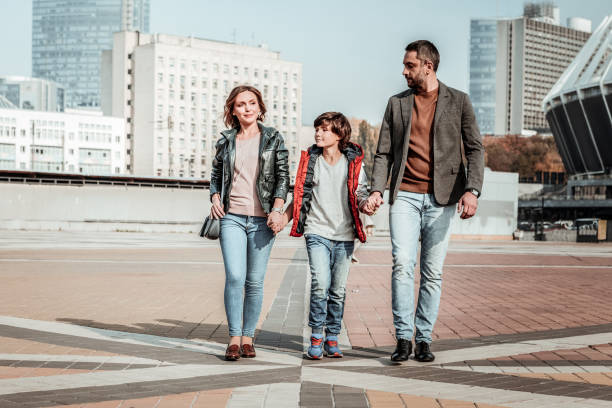istock Mother and father walking with their kid 1085369068
