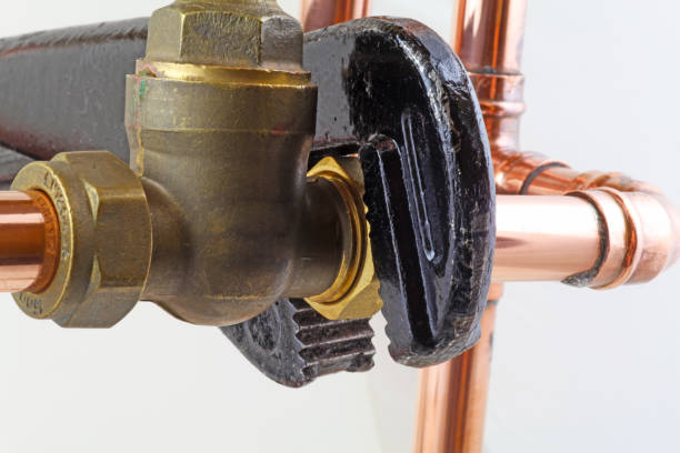 istock Plumber's wrench tightening up a valve 1085377520