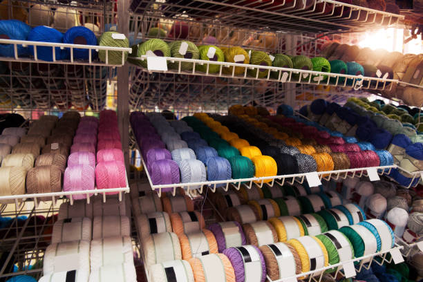 istock Many multi-colored threads on the shelf of the store. 1085385792