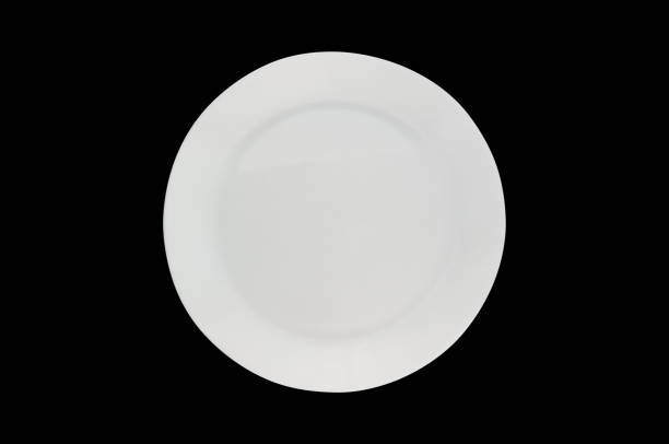 istock One ceramic circle fragile plate isolated on black background. Top view 1085386378