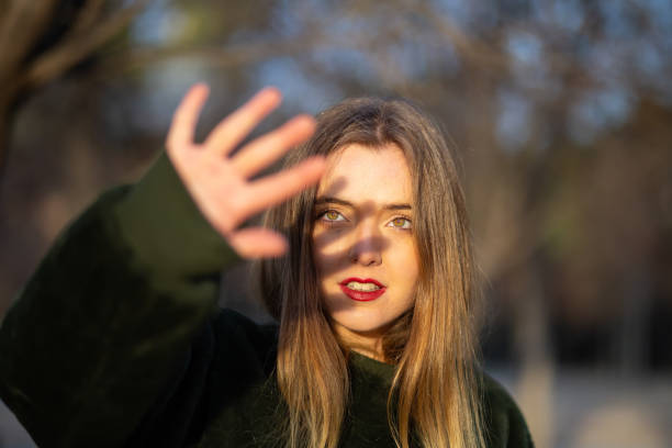 istock Young woman covering face from sunlight 1085386452