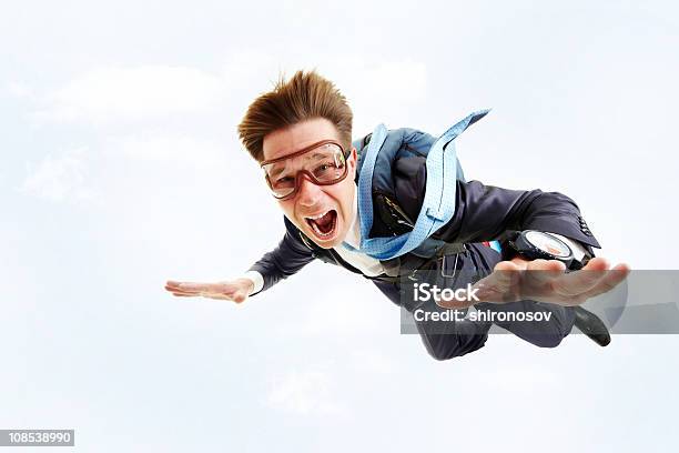 A Man In A Blue Suit And Goggles Parachuting Stock Photo - Download Image Now - Fear, Parachute, Parachuting