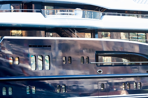 Closeup side view of luxury yacht at harbour, copy space, horizontal composition with copy space