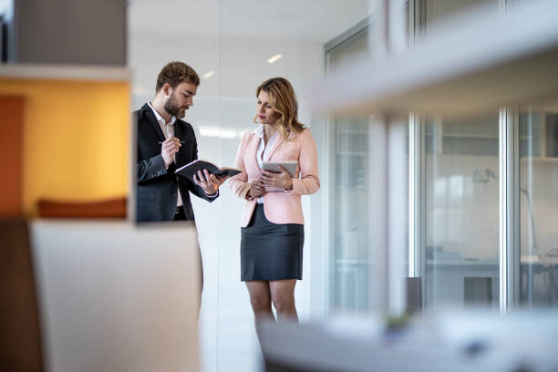 istock Business Colleagues Discussing in The Corridor 1085392838