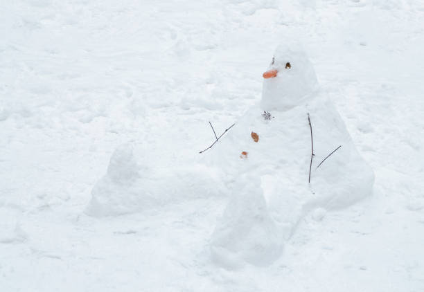 istock Snowman cobbled together by children. 1085394524