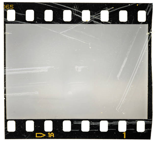 scratched 35mm filmstrip or film frame on white, old retro vintage film material, macro photo stock photo
