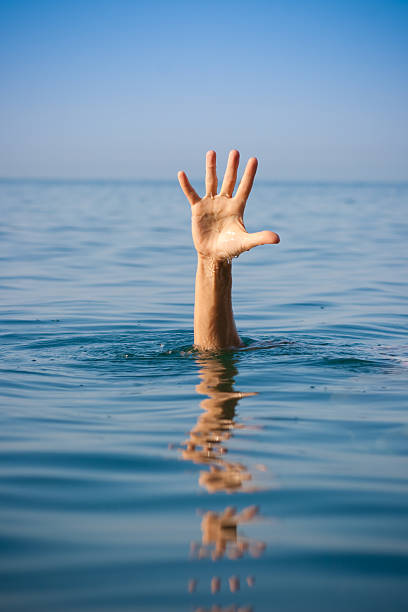 istock single hand of drowning man in sea asking for help 108539512