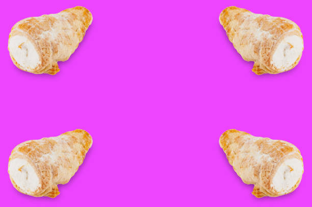istock Four baked rolls with cream in corners on violet background with copy space for your text 1085398448