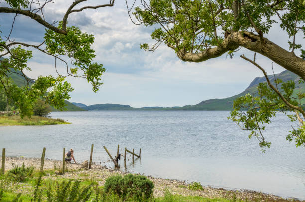 una donna al lago wastwater in cumbria, inghilterra - screes foto e immagini stock