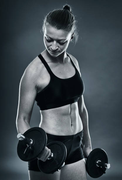 istock Girl doing biceps curl with dumbbells 1085429220