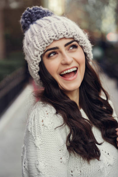 istock Cute brunette in a white sweater in a city 1085439202