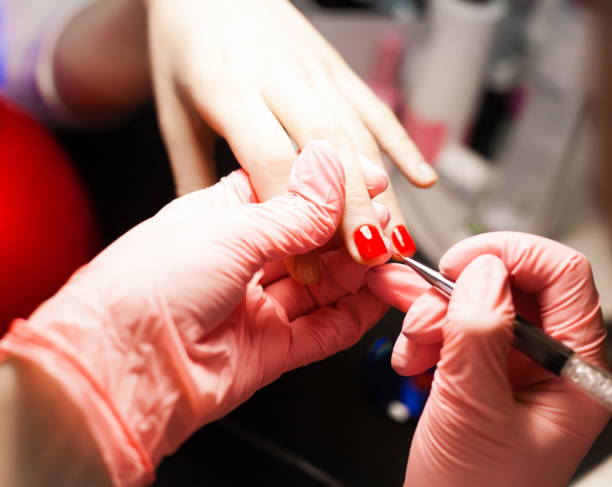 istock Cosmetics. Hands, nails manicure, paint,  brushes, red 1085445468