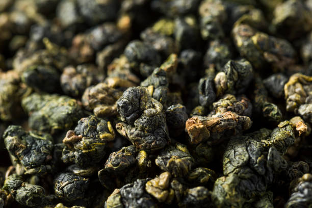 Dried Organic Oolong Pearl Tea Dried Organic Oolong Pearl Tea in a Bowl oolong tea stock pictures, royalty-free photos & images