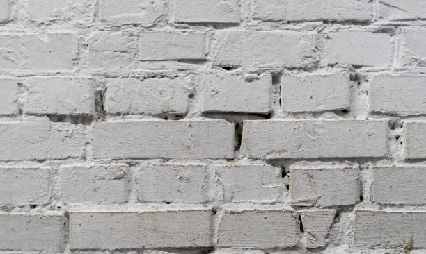 istock Tiled old painted white brick wall background in Kyiv, Ukraine 1085451350