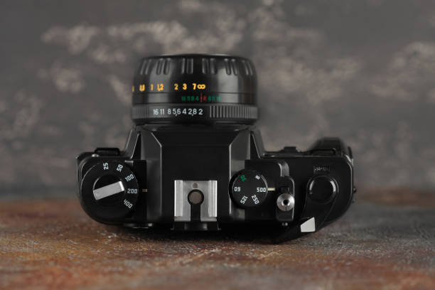 istock The old 35 mm SLR camera on gray-brown cement background. 1085451606