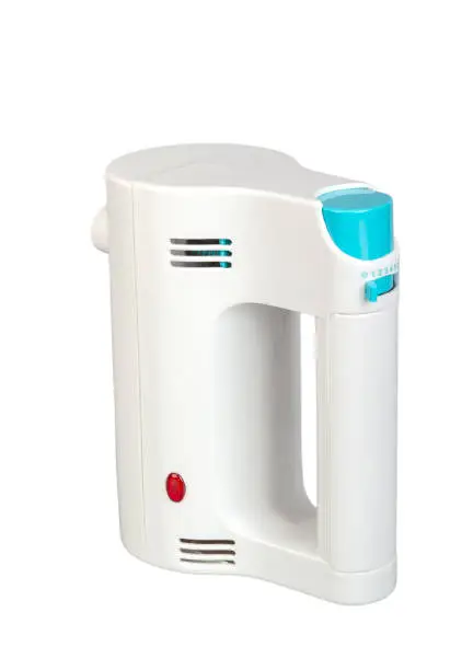 Electric hand mixer is a kitchen appliance intended for mixing isolated on white background