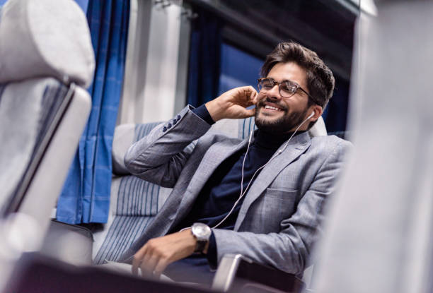 istock Young man enjoying music while traveling by train 1085465072