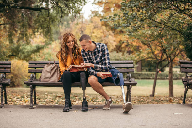 istock Couple studying together in park on bench 1085466716