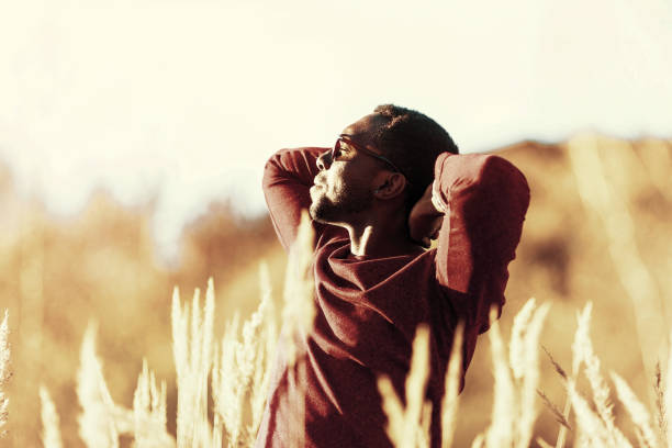 istock stylish young black man in sunglasses in a field 1085468994