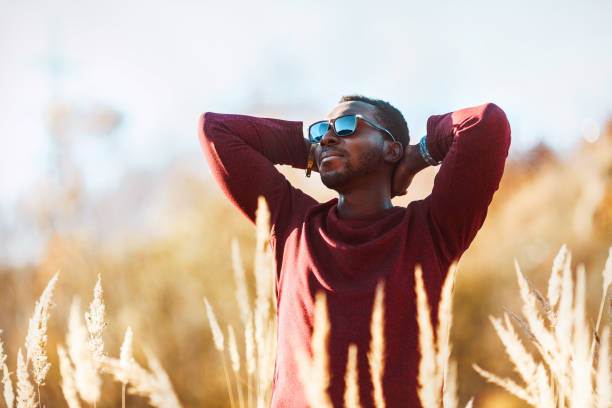 istock stylish young black man in sunglasses in a field 1085469042