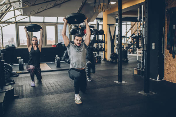 istock Girl practicing together with personal trainer in gym 1085470212