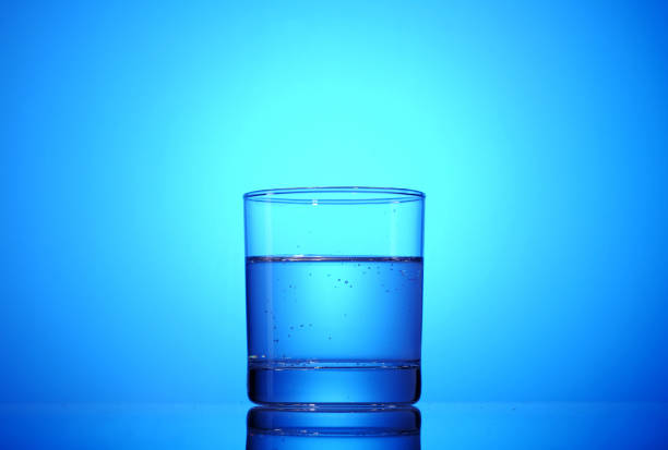 Glass with mineral water on a beautiful blue background.