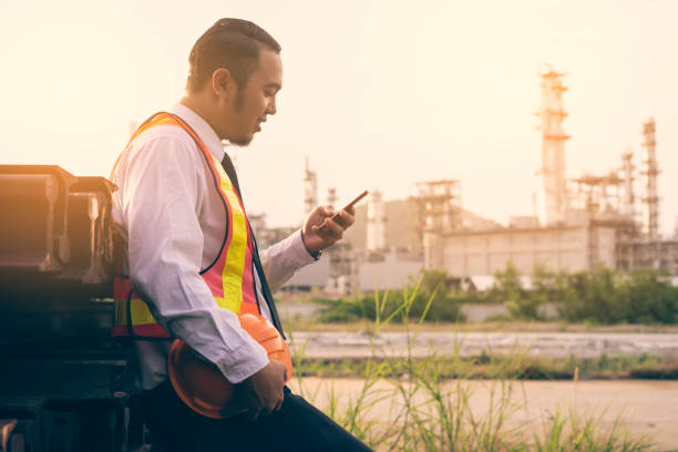 istock Engineer worker Concept working at oil refinery. Young Asian men worker and electrician work safety control at power plant energy industry. Control and safety. 1085475642