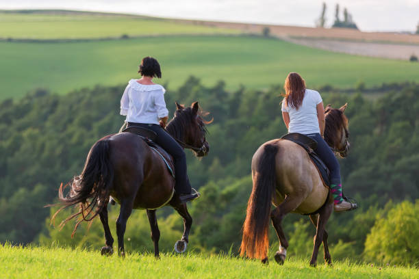 istock two women riding horses 1085479438