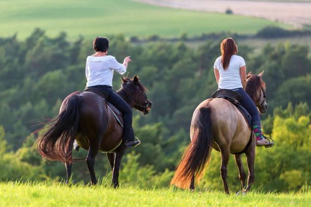 istock two women riding horses 1085479442