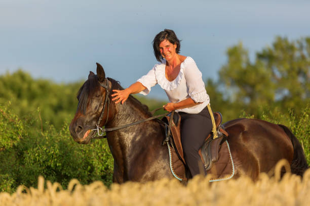 istock woman sits on an Andalusian horse 1085479620