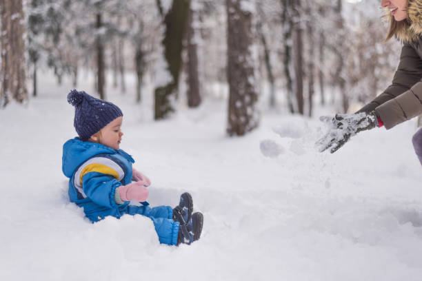 istock Mother and child playing in snow and having fun 1085481232