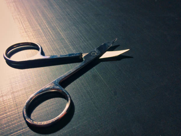 istock nail scissors on a dark background, nail scissors, small scissors, dark background 1085494948