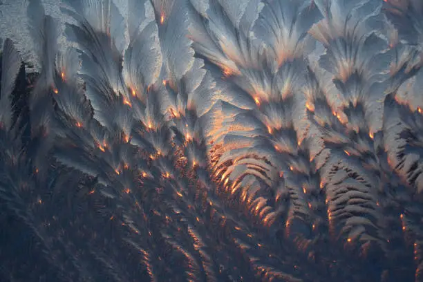 frosty pattern of ice crystals on the window glass