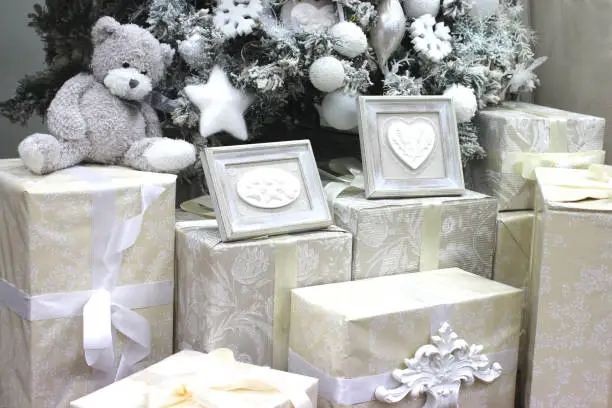white fluffy toy bear sitting with Christmas interior gifts
