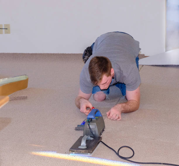 istock Young man laying carpet in room 1085540510