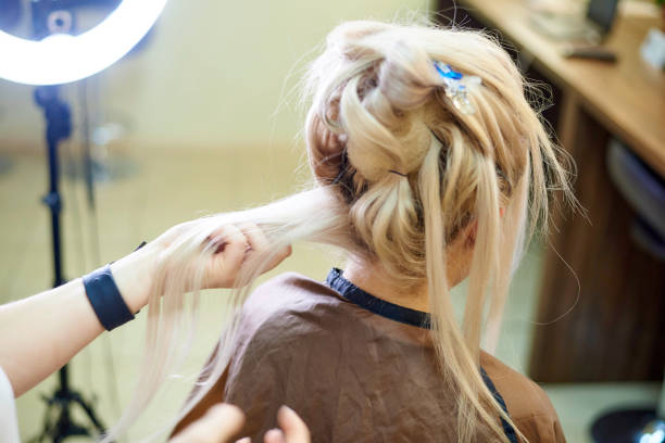 istock Hairdressing services. Creating an evening hairstyle. Hair styling process. 1085555918